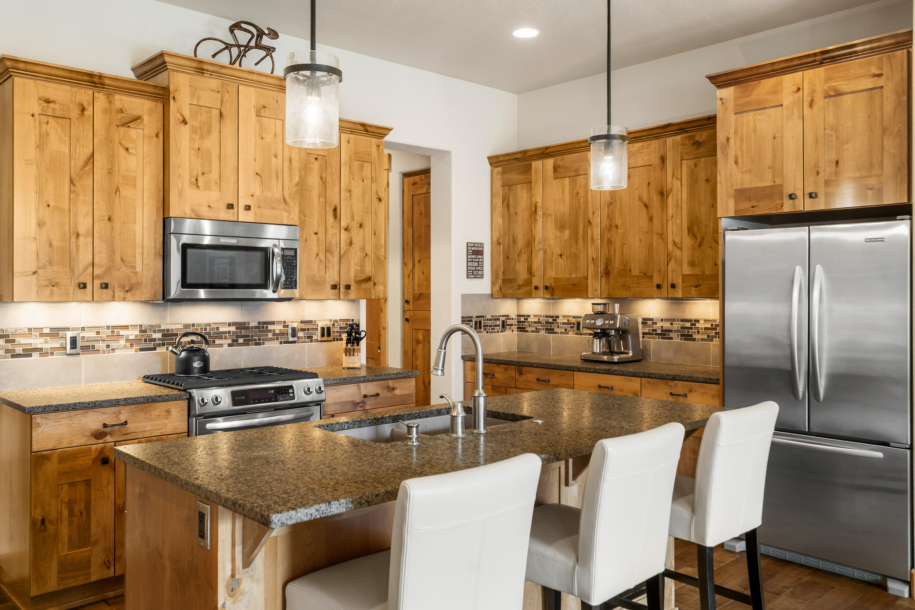 18667 Coffee Court Bend, OR 97702 - Photo 16 of 30 a kitchen with stainless steel appliances granite countertop a sink a stove and a refrigerator