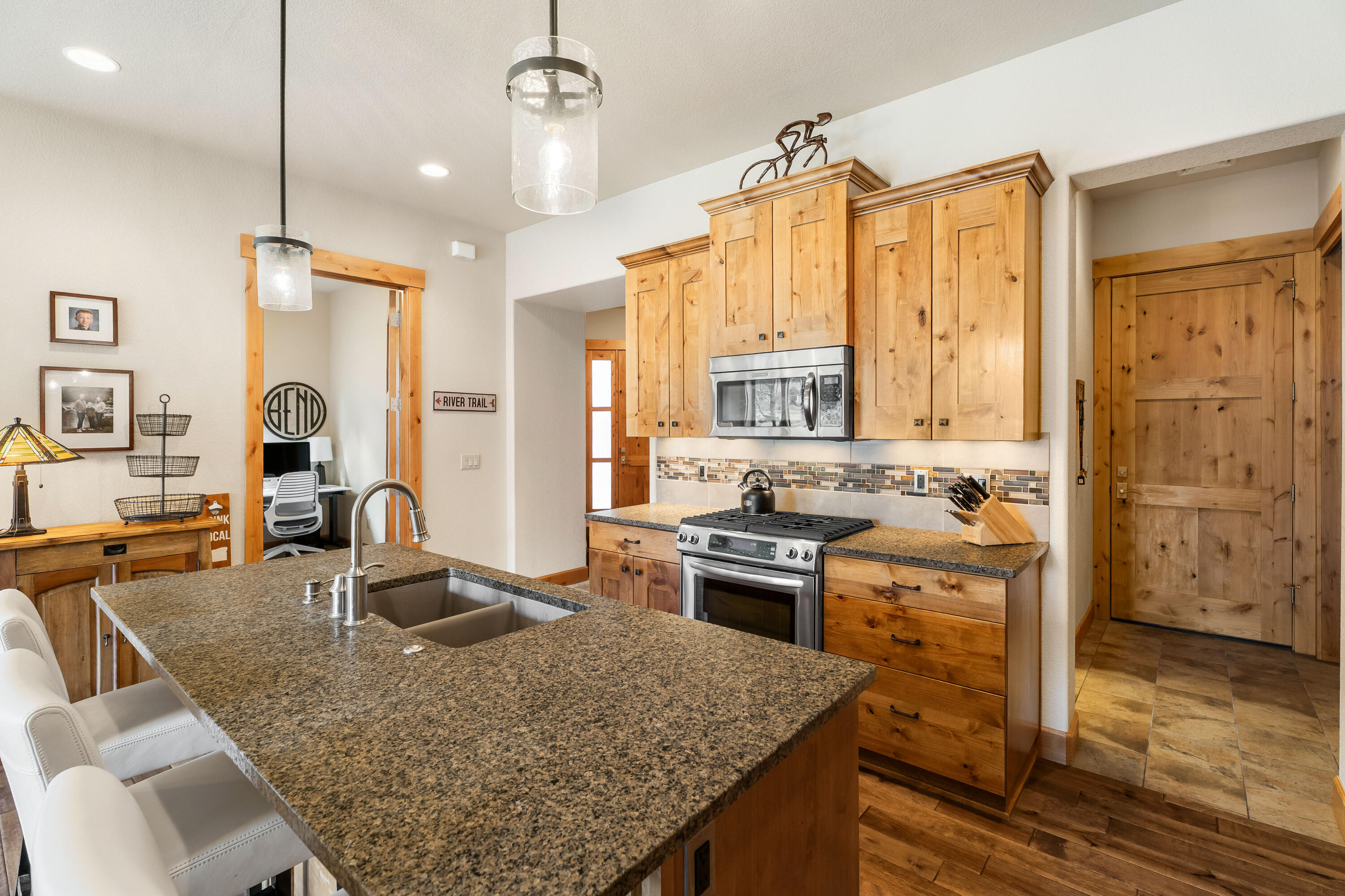 18667 Coffee Court Bend, OR 97702 - Photo 17 of 30 a kitchen with stainless steel appliances granite countertop a sink stove and refrigerator
