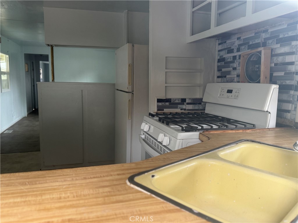 5877 Lake Street, Unit 23 Lucerne, CA 95458 - Photo 13 of 19 a kitchen with a stove and a refrigerator