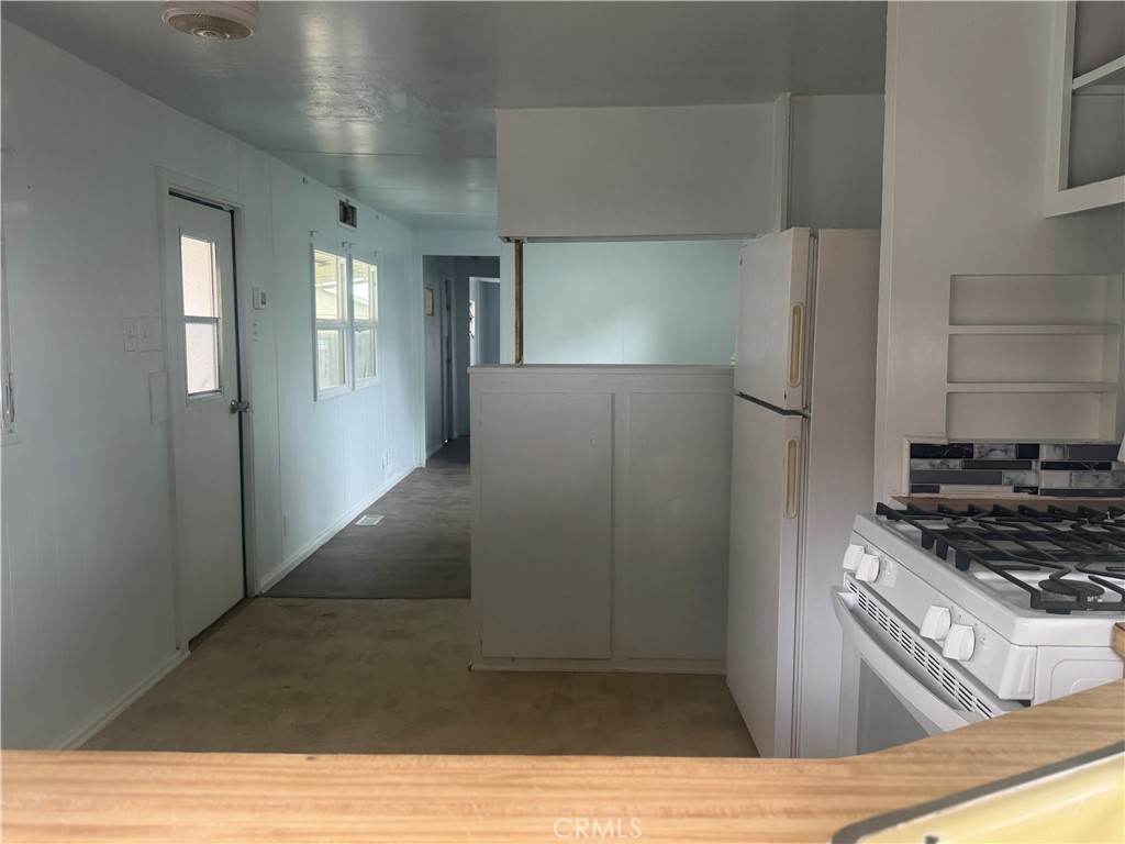 5877 Lake Street, Unit 23 Lucerne, CA 95458 - Photo 14 of 19 a kitchen with stainless steel appliances a refrigerator and a stove top oven