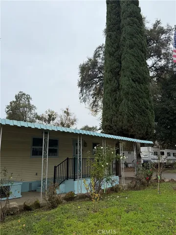 a backyard of a house with table and chairs
