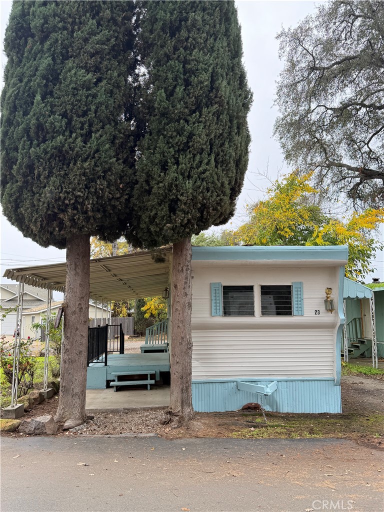 5877 Lake Street, Unit 23 Lucerne, CA 95458 - Photo 2 of 19 a white house that has a tree in front of it