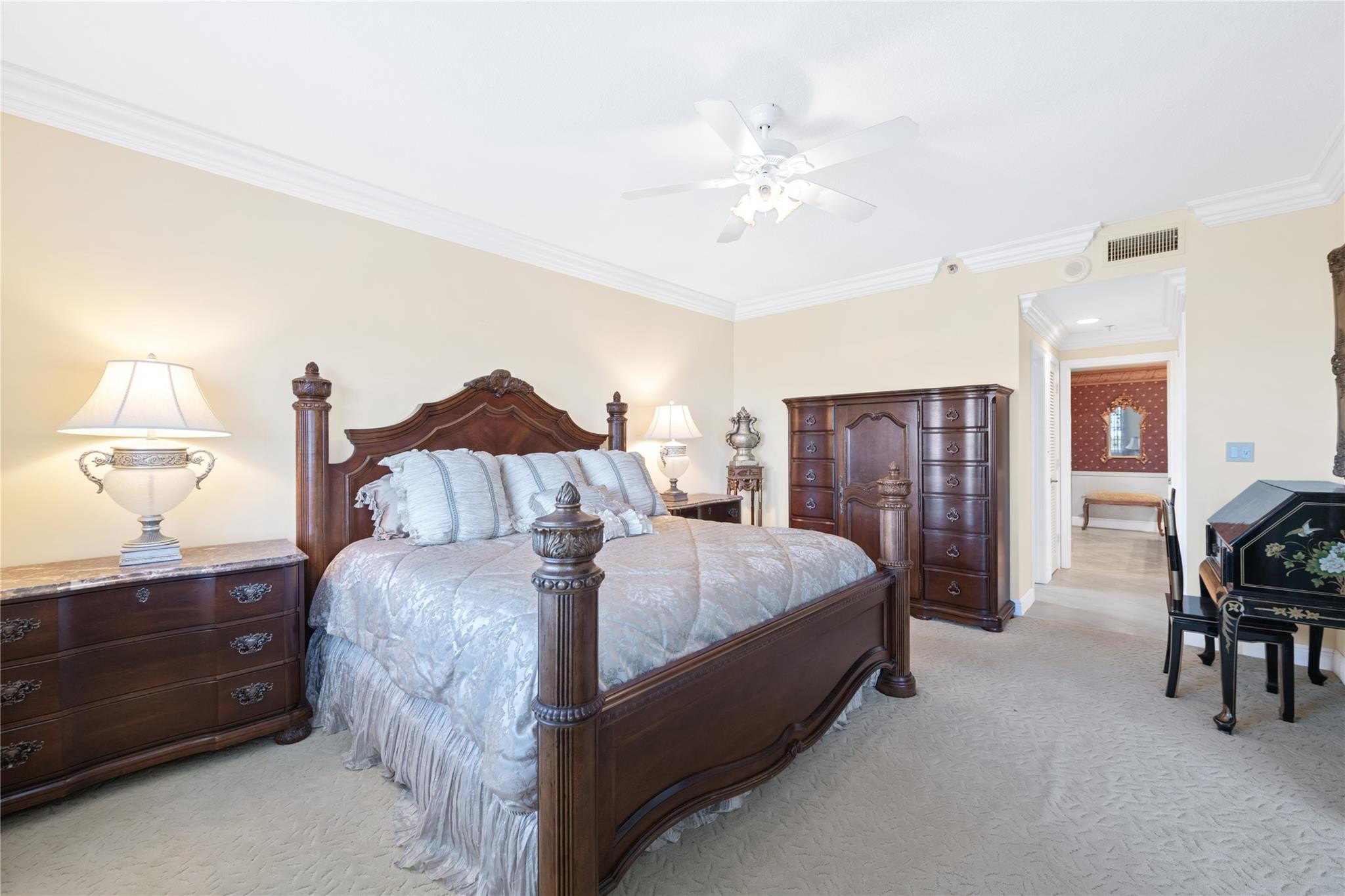 17031 Boca Club Boulevard, Unit 85A Boca Raton, FL 33487 - Photo 12 of 49 a spacious bedroom with a bed and lamp chandelier