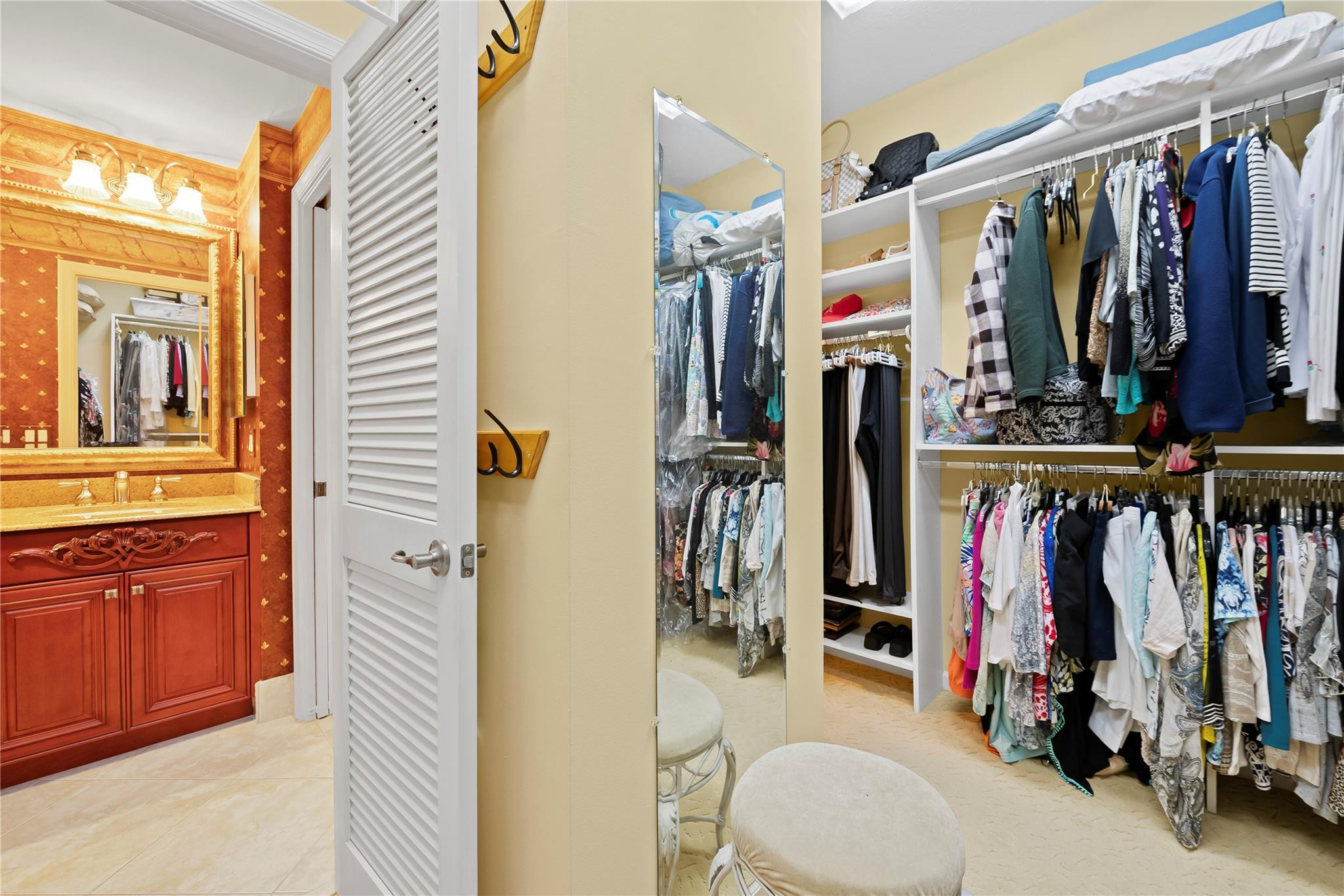 17031 Boca Club Boulevard, Unit 85A Boca Raton, FL 33487 - Photo 14 of 49 a view of walk in closet with clothes and shoes