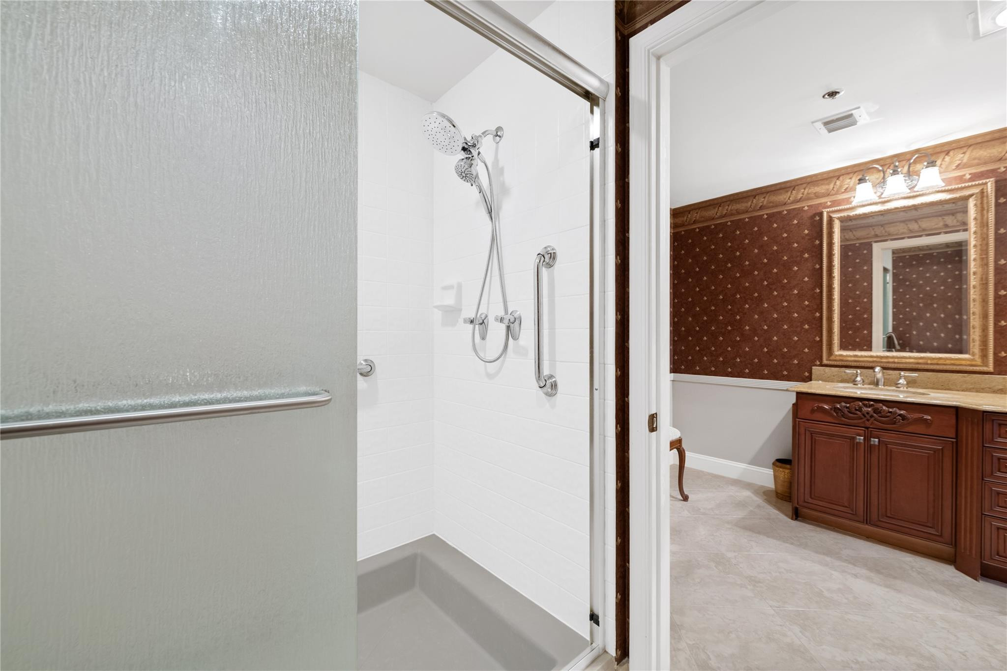 17031 Boca Club Boulevard, Unit 85A Boca Raton, FL 33487 - Photo 18 of 49 a bathroom with a shower sink and mirror