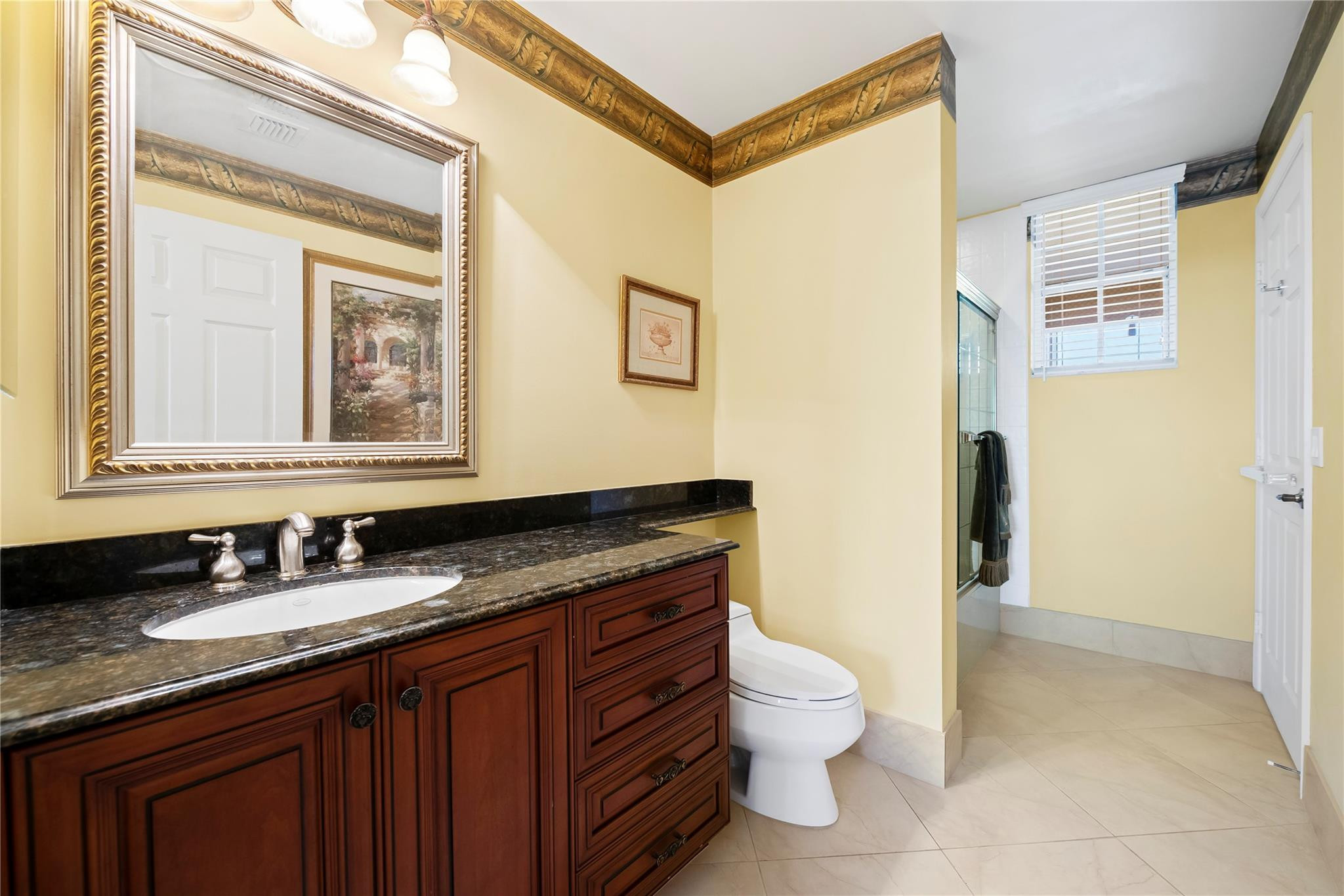 17031 Boca Club Boulevard, Unit 85A Boca Raton, FL 33487 - Photo 22 of 49 a bathroom with a granite countertop sink toilet and shower