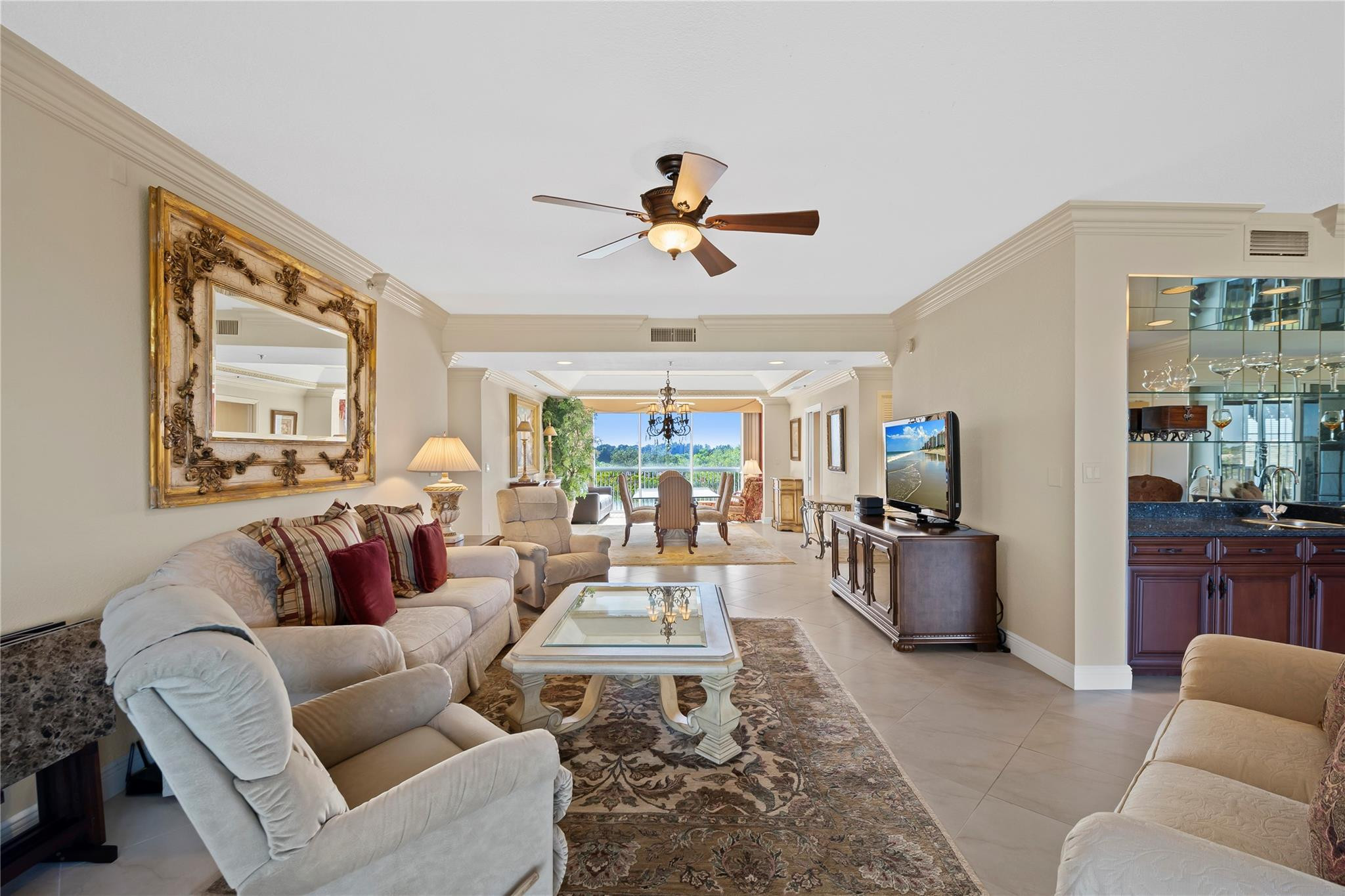 17031 Boca Club Boulevard, Unit 85A Boca Raton, FL 33487 - Photo 30 of 49 a living room with furniture a flat screen tv and a large window