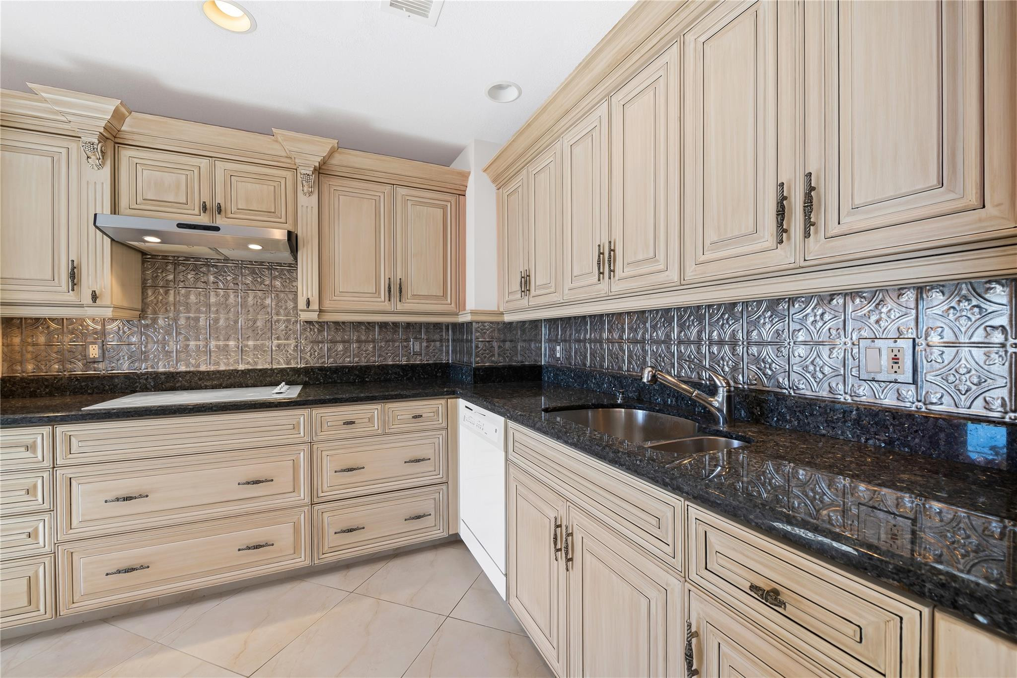 17031 Boca Club Boulevard, Unit 85A Boca Raton, FL 33487 - Photo 3 of 49 a kitchen with granite countertop white cabinets sink and stainless steel appliances