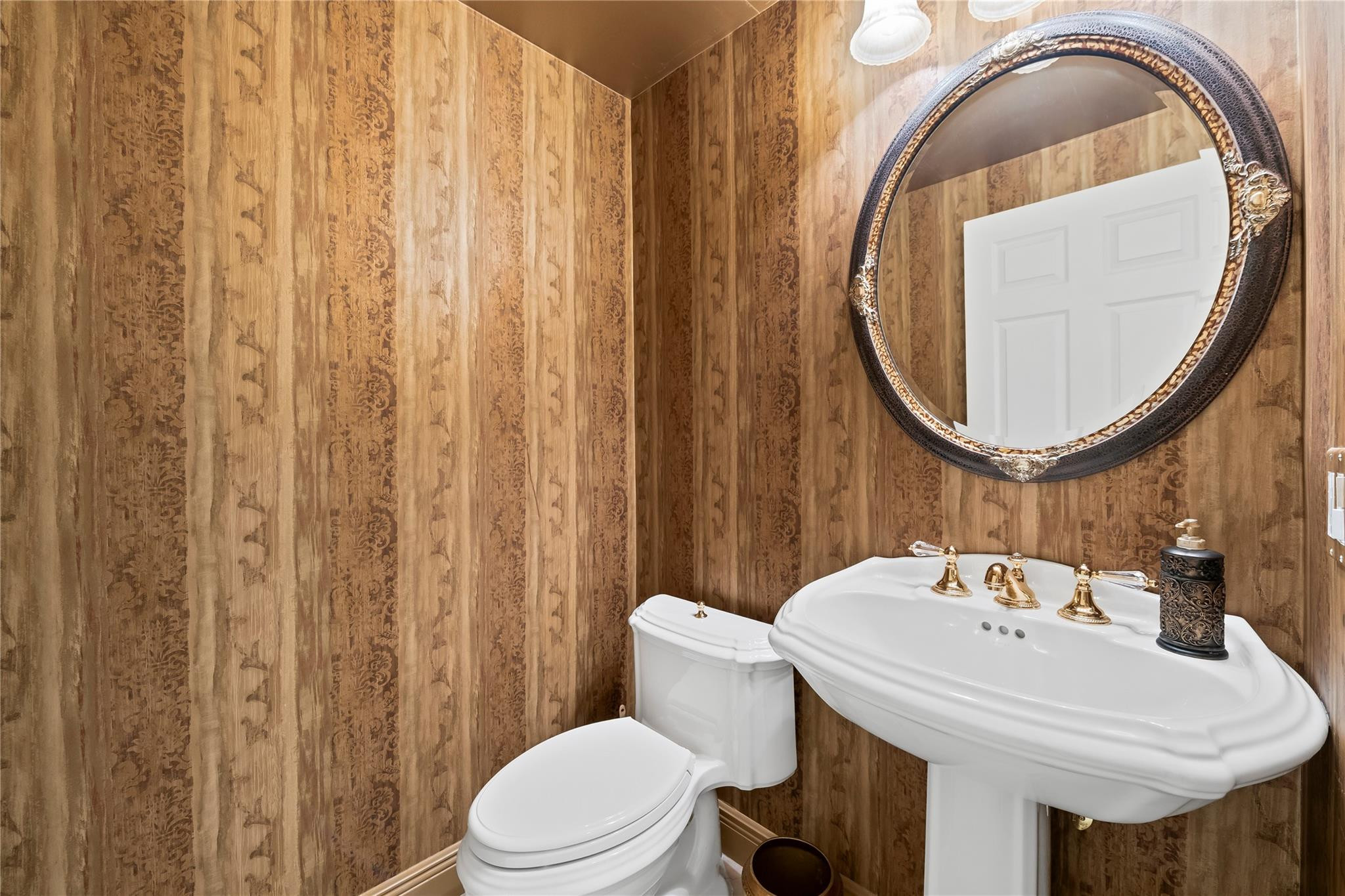 17031 Boca Club Boulevard, Unit 85A Boca Raton, FL 33487 - Photo 32 of 49 a bathroom with a sink a toilet and a mirror