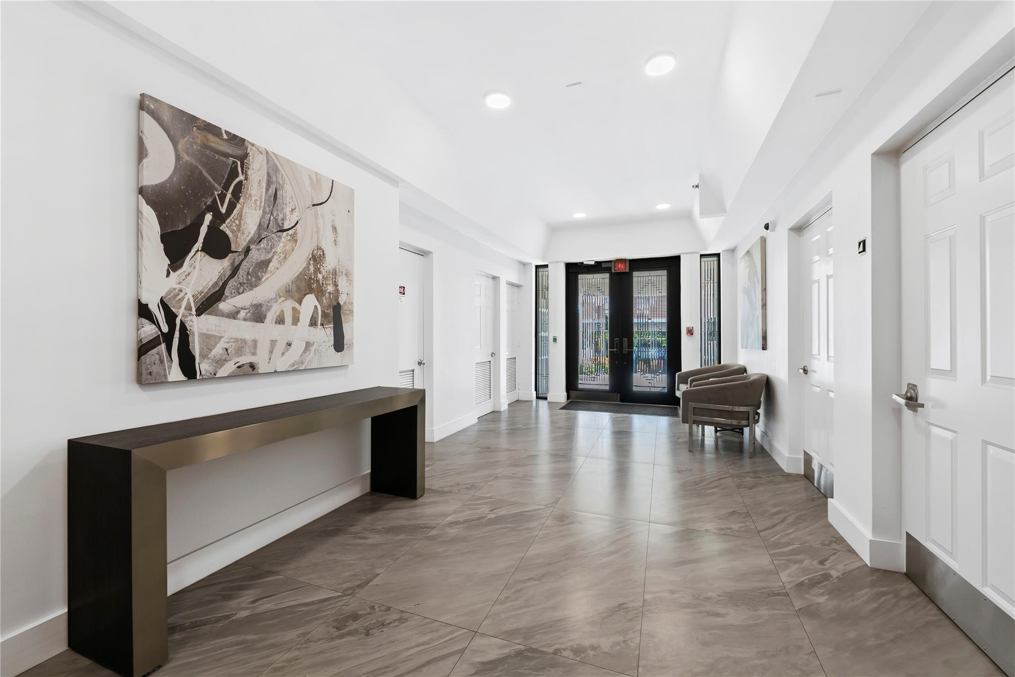 17031 Boca Club Boulevard, Unit 85A Boca Raton, FL 33487 - Photo 39 of 49 a view of a hallway with wooden floor and furniture