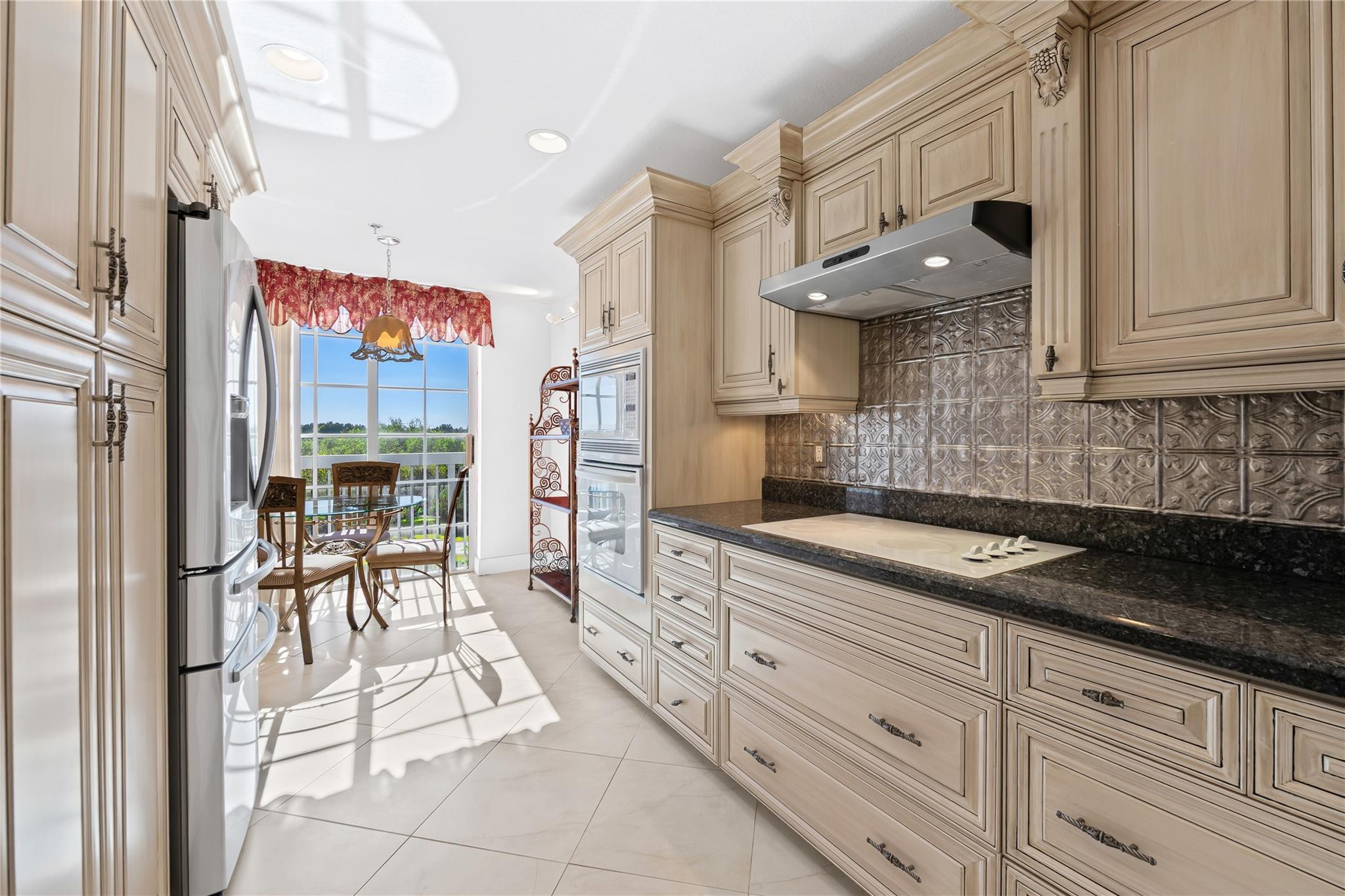 17031 Boca Club Boulevard, Unit 85A Boca Raton, FL 33487 - Photo 4 of 49 a kitchen with granite countertop a sink and cabinets