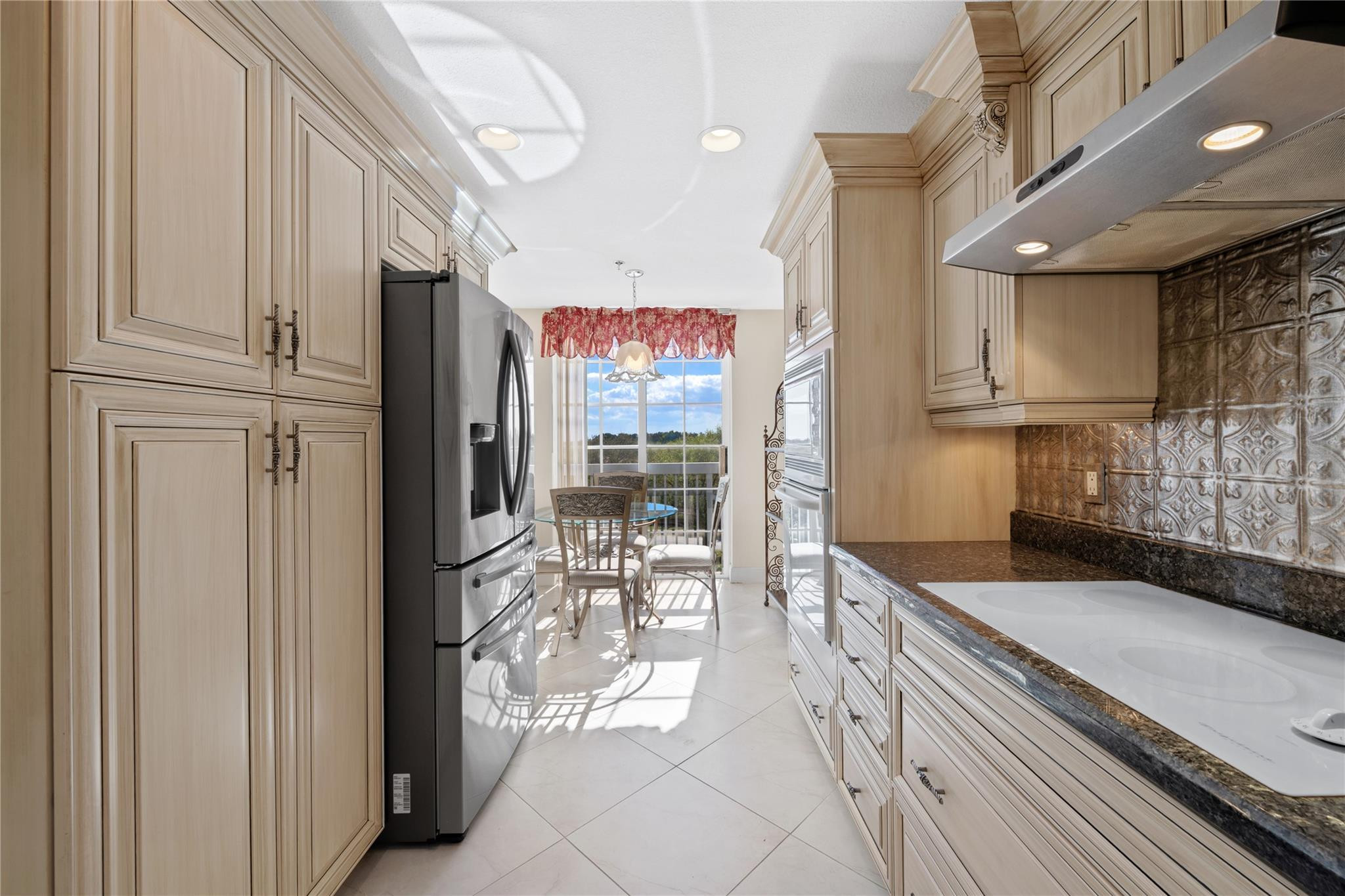 17031 Boca Club Boulevard, Unit 85A Boca Raton, FL 33487 - Photo 5 of 49 a kitchen with stainless steel appliances granite countertop a refrigerator and a sink