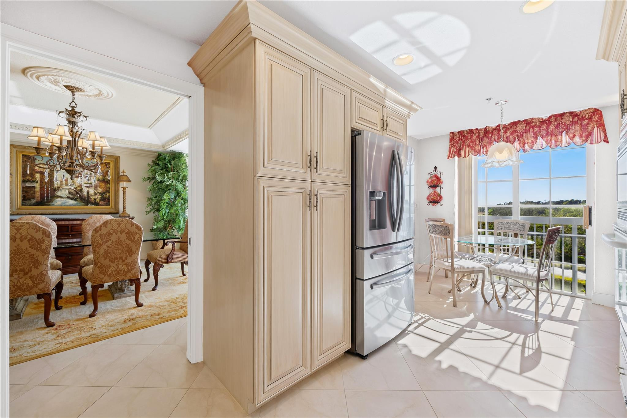 17031 Boca Club Boulevard, Unit 85A Boca Raton, FL 33487 - Photo 6 of 49 a kitchen with stainless steel appliances a refrigerator and table chair