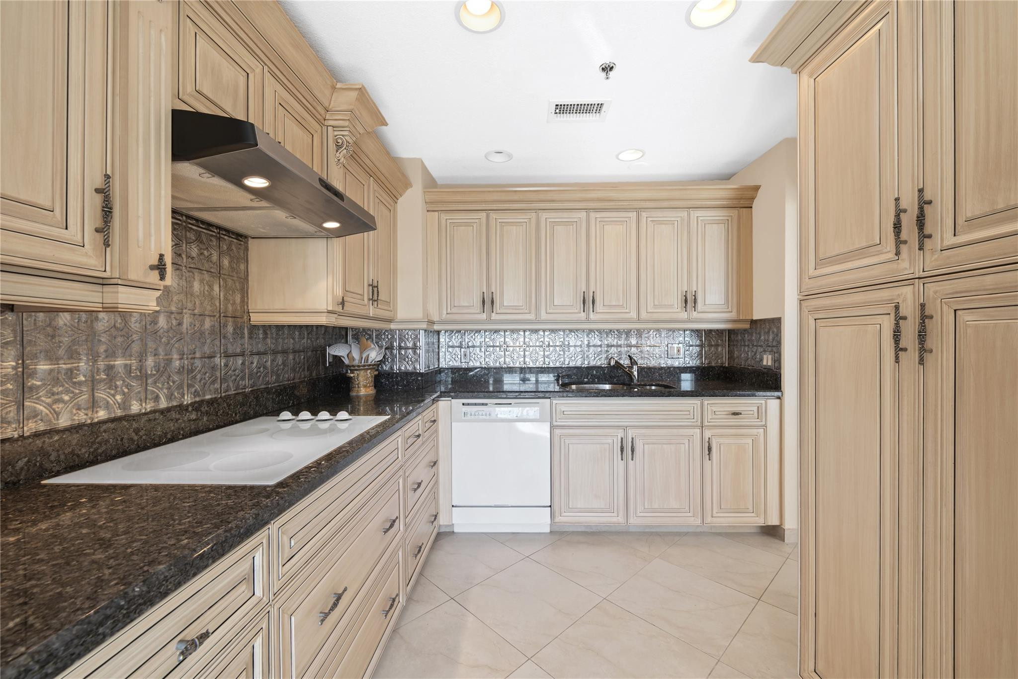 17031 Boca Club Boulevard, Unit 85A Boca Raton, FL 33487 - Photo 7 of 49 a kitchen with granite countertop a sink a stove and cabinets