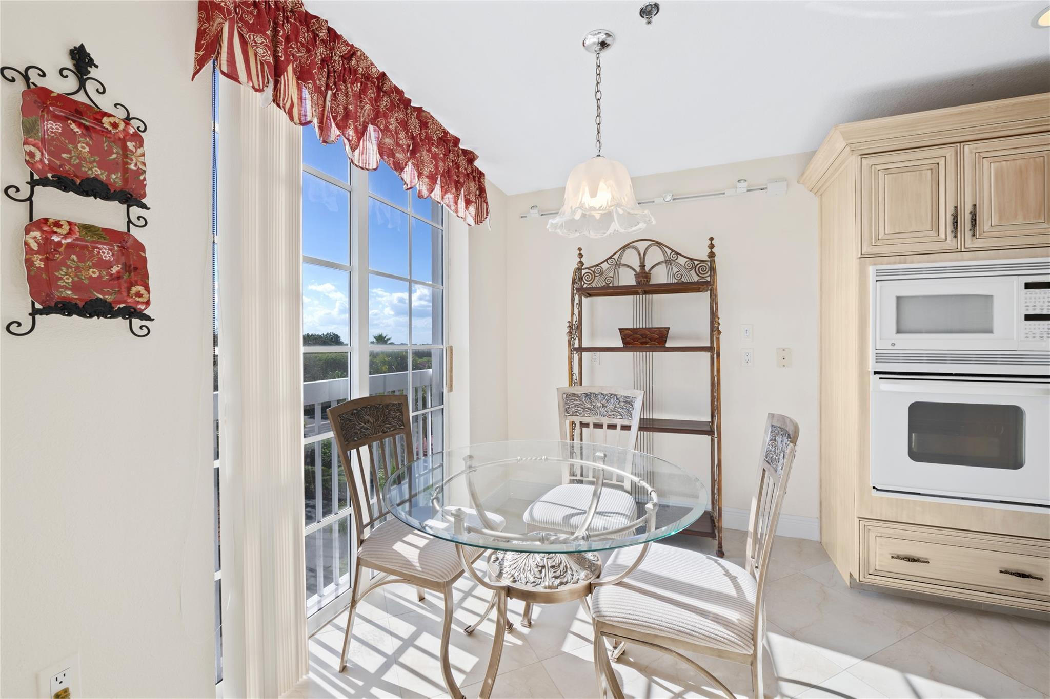 17031 Boca Club Boulevard, Unit 85A Boca Raton, FL 33487 - Photo 9 of 49 a view of a dining room with furniture and chandelier