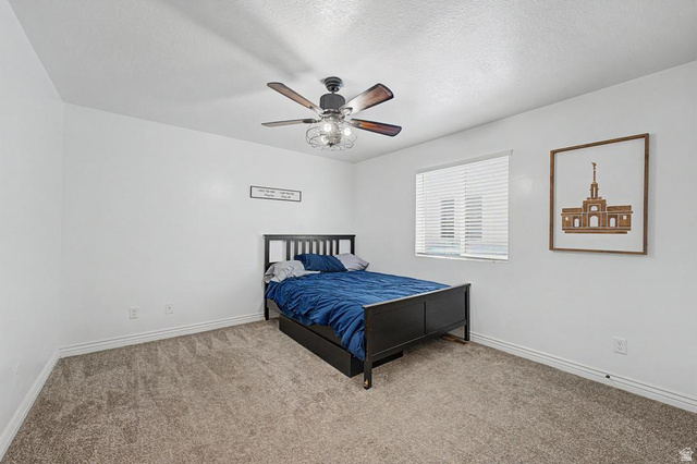 1692 South Windemere Road Santaquin, UT 84655 - Photo 7 of 23 Bedroom featuring neutral wall paint, gray carpet flooring, a ceiling fan with integrated lighting, and a single window with blinds