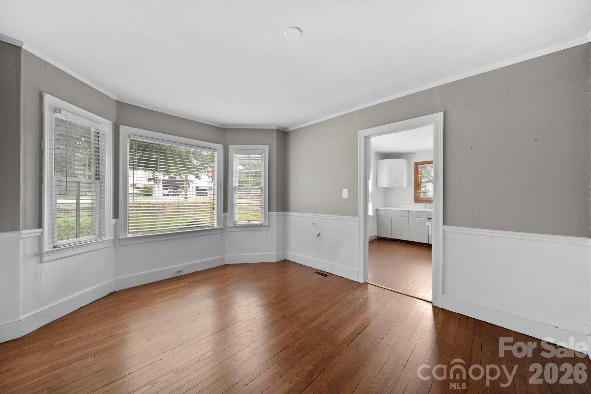 1109 Union Road Gastonia, NC 28054 - Photo 7 of 44 an empty room with wooden floor and windows