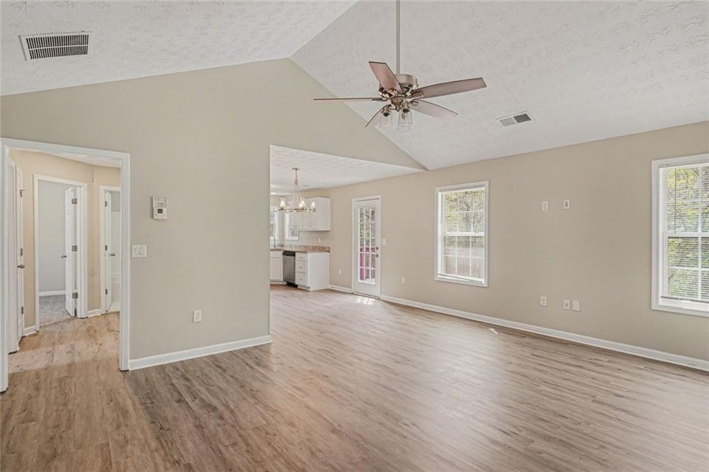 10 Wilbur Way Covington, GA 30016 - Photo 3 of 22 a view of an empty room with wooden floor and a window