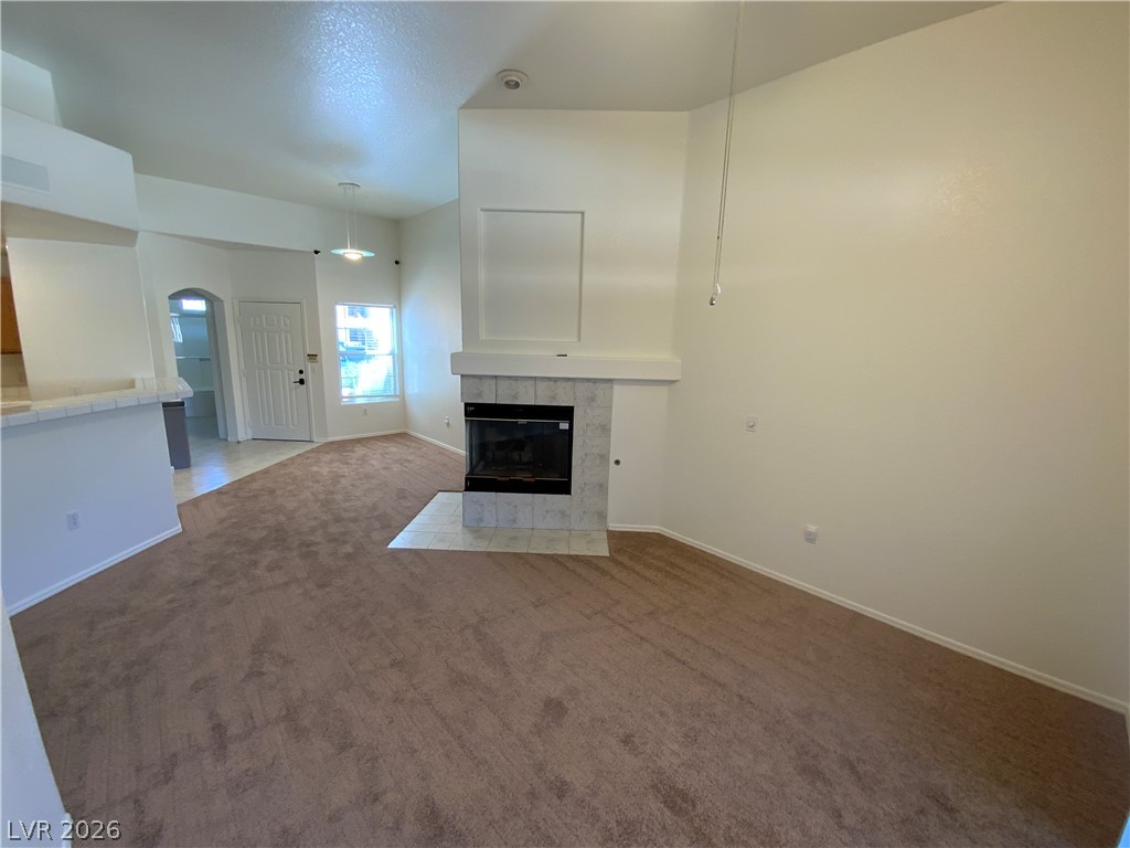 7400 West Flamingo Road, Unit 1039 Las Vegas, NV 89147 - Photo 4 of 40 A cozy living space features vaulted ceilings and a warm fireplace.