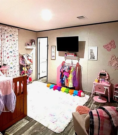 a bedroom with bed and a flat screen tv
