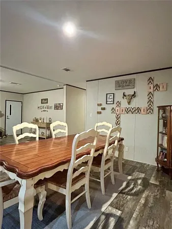 a dining room with furniture and wooden floor