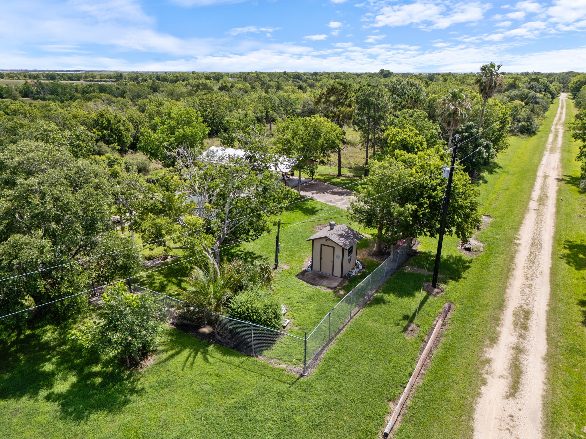 182 Smith Road Palacios, TX 77465 - Photo 9 of 23 a view of a garden with a building in the background