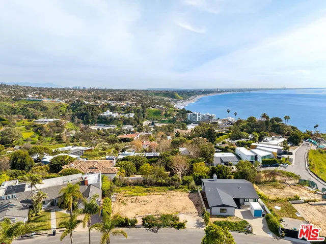 an aerial view of residential houses with city view