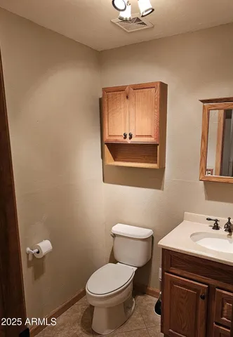 a bathroom with a sink a toilet and mirror
