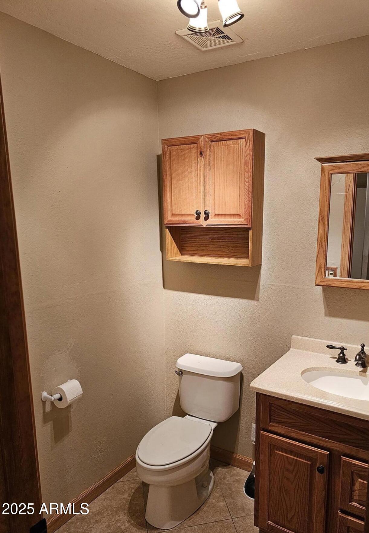 139 North Carter Ranch Road Coolidge, AZ 85128 - Photo 5 of 28 a bathroom with a sink a toilet and mirror