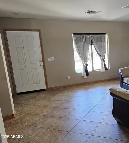 a view of a livingroom with wooden floor and a window