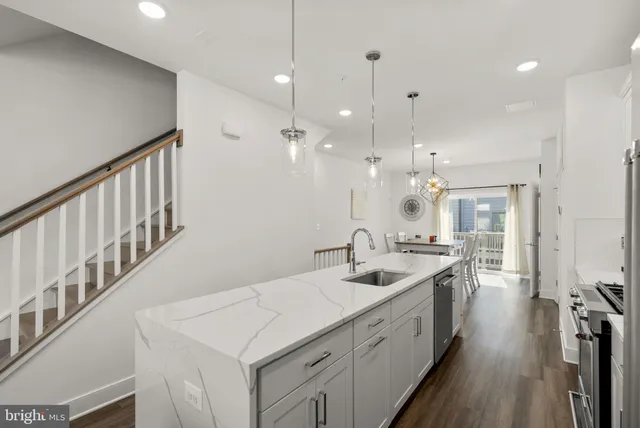 a kitchen with stainless steel appliances sink stove microwave and cabinets