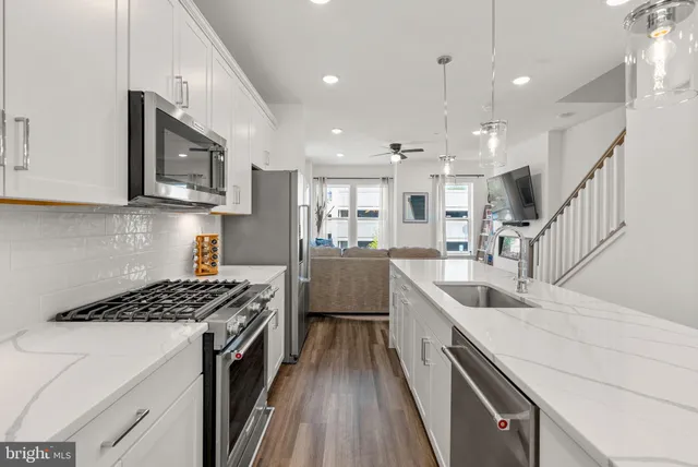 a kitchen with sink cabinets and wooden floor