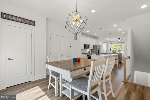 a view of a dining room with furniture wooden floor and a chandelier