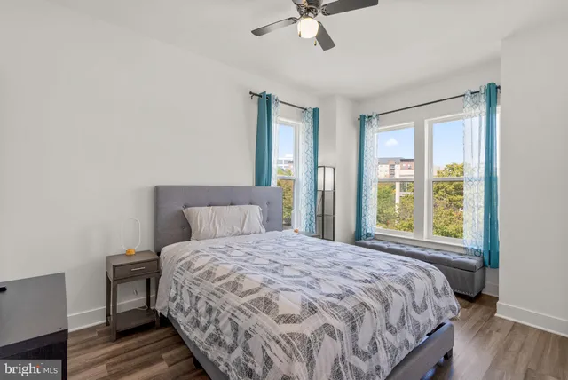 a bedroom with a bed and a large window