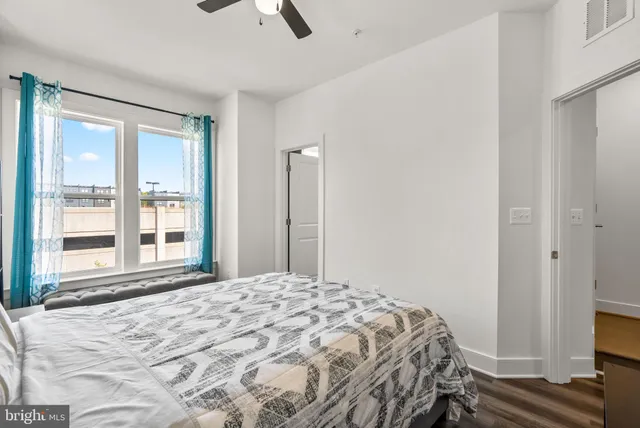 a bedroom with a bed and a flat tv screen on a dresser