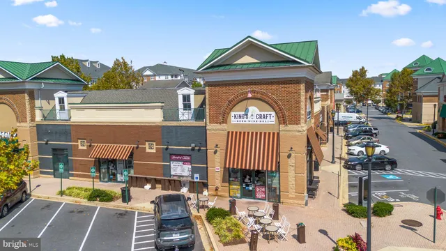 a front view of a building with parked cars