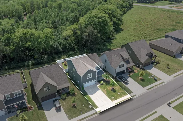 a view of a house with a yard and potted plants