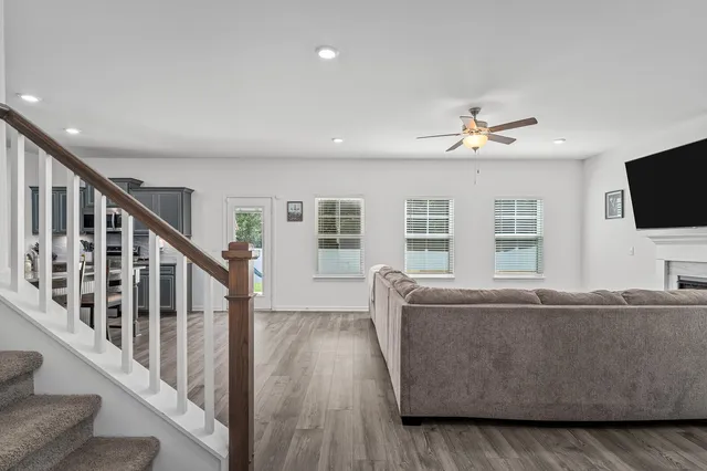 a kitchen with refrigerator and chairs