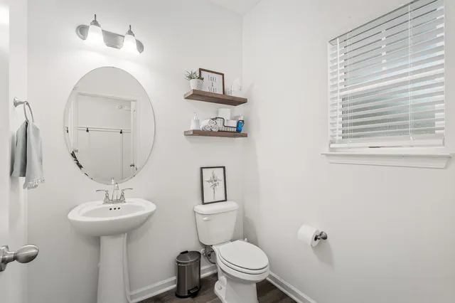 a view of a house with a yard and a large tree