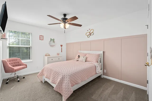 an aerial view of a house with garden space and street view