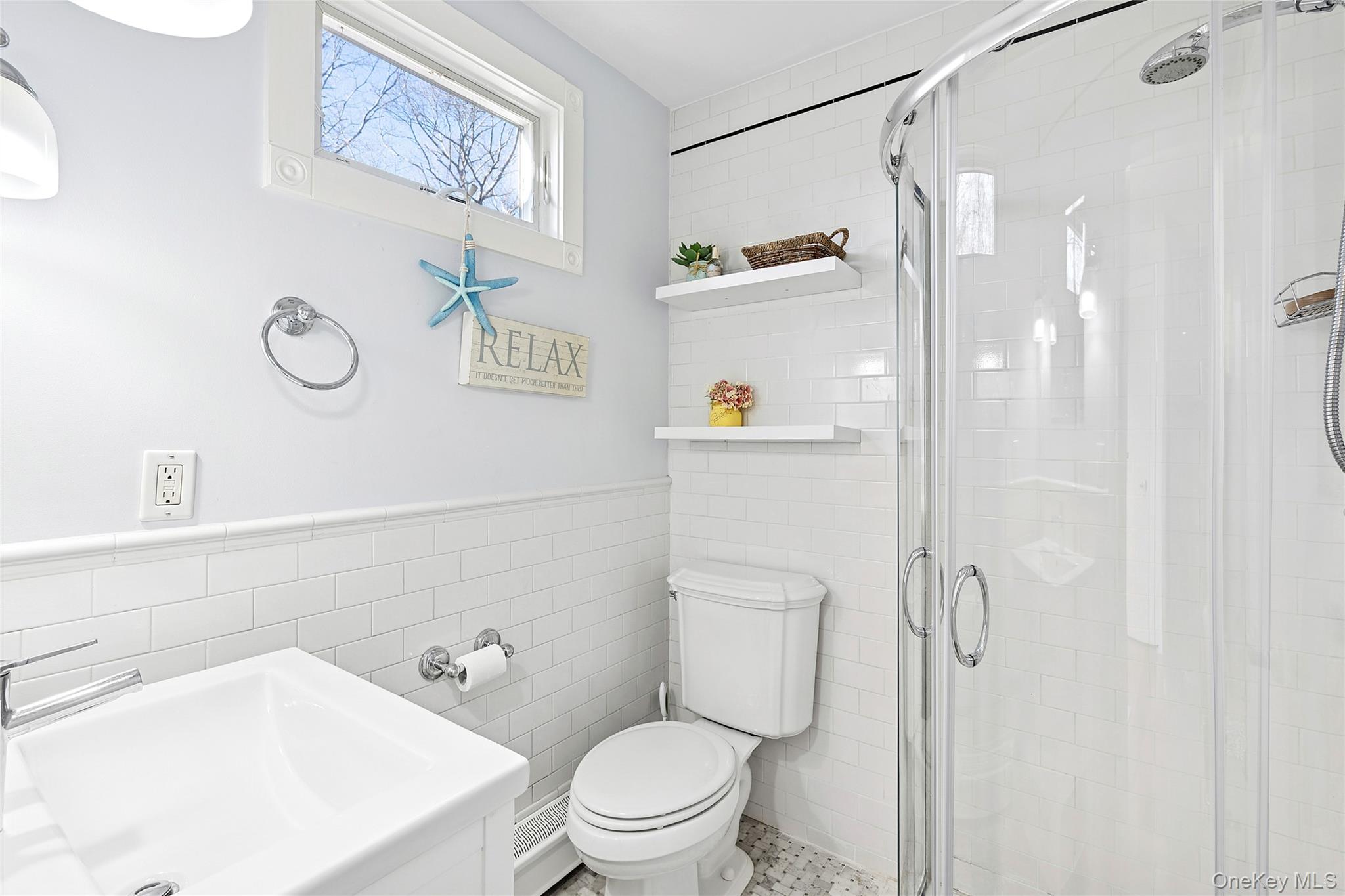 364 Three Mile Harbor Road East Hampton, NY 11937 - Photo 12 of 18 a white toilet sitting next to a bathroom sink