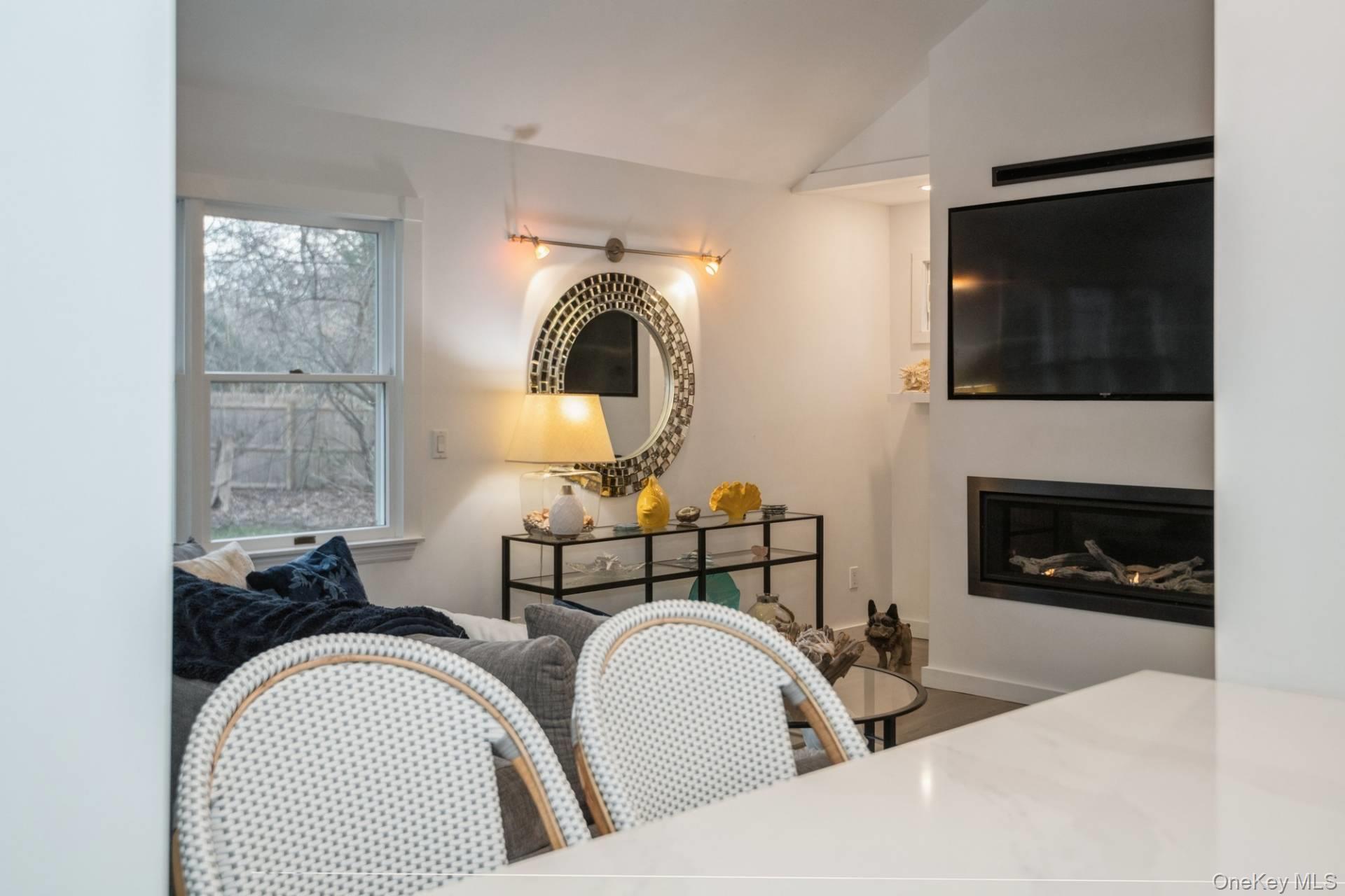 364 Three Mile Harbor Road East Hampton, NY 11937 - Photo 6 of 18 a living room with fireplace furniture and a flat screen tv