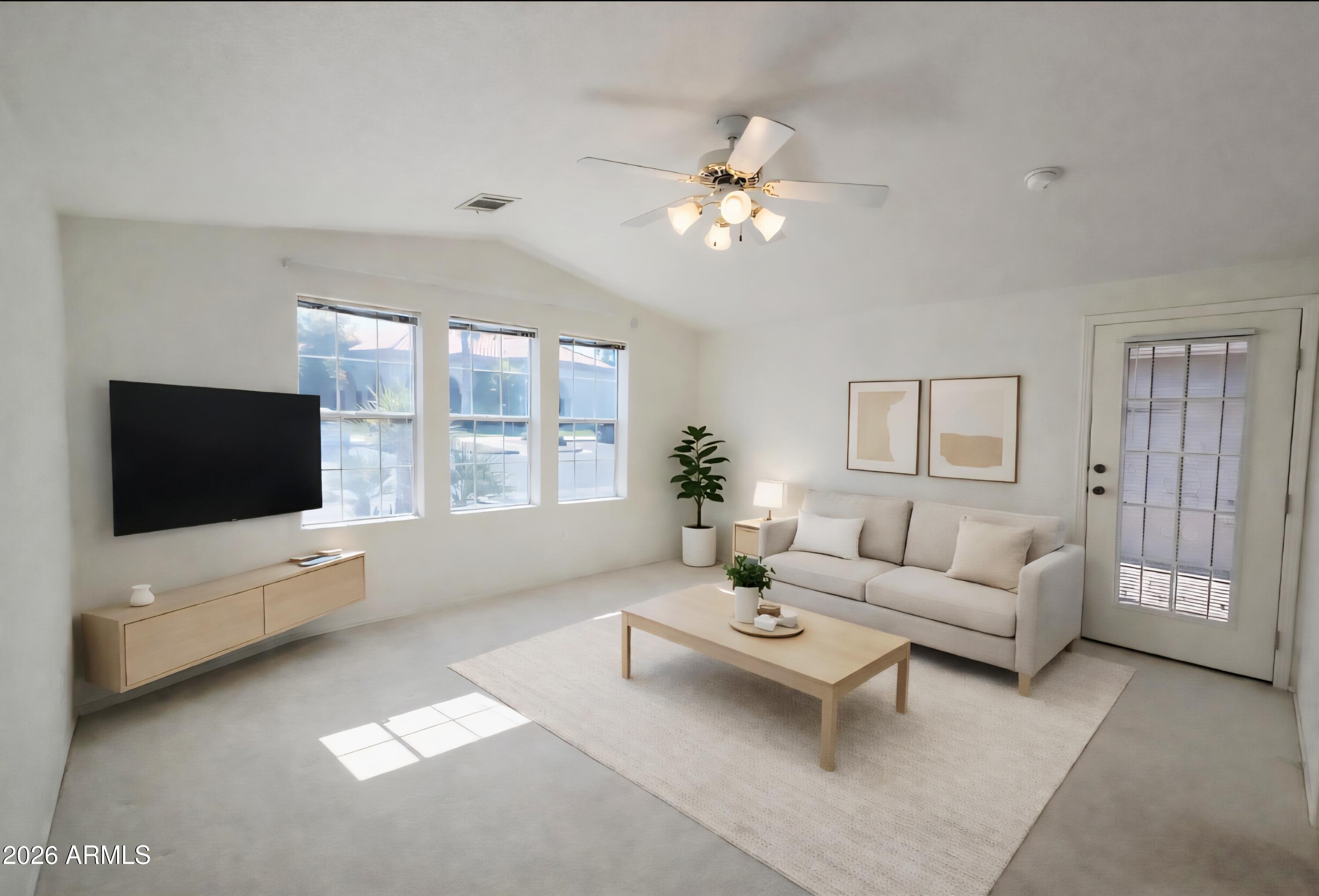 3301 South Goldfield Road, Unit 3004 Apache Junction, AZ 85119 - Photo 31 of 67 a living room with furniture a flat screen tv and a large window