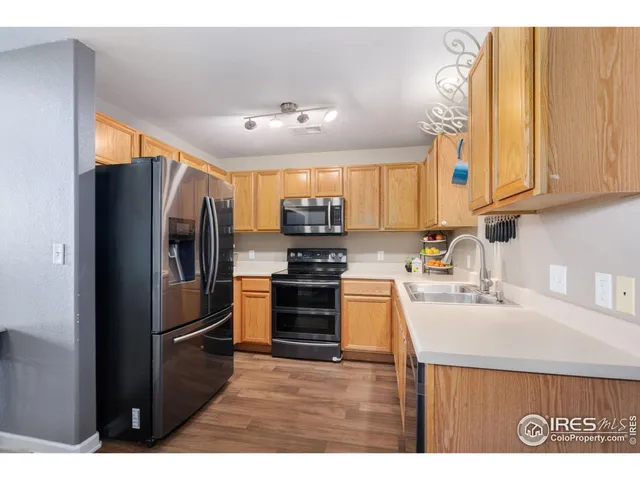 a kitchen with stainless steel appliances granite countertop a refrigerator sink and stove