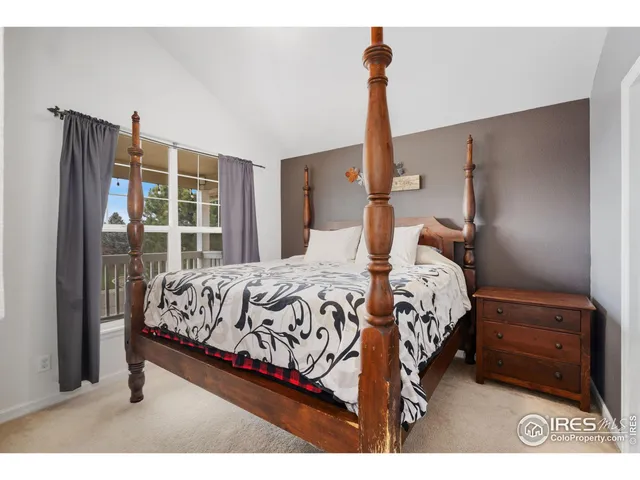 a bedroom with a bed next to a window with outer view