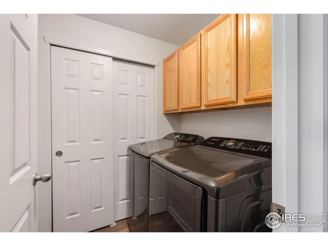 a kitchen with a sink a stove cabinets and a window