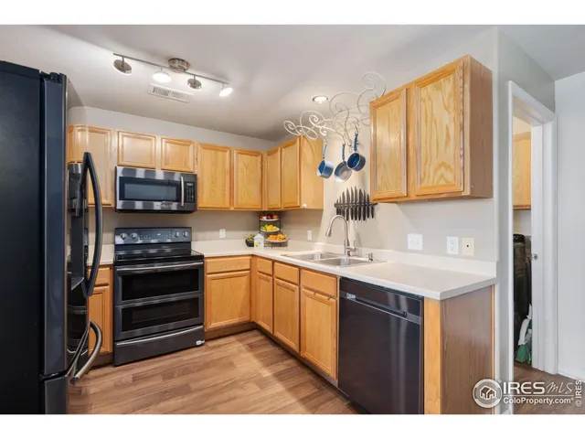 a kitchen with a sink appliances and cabinets
