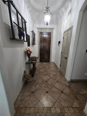 a kitchen with granite countertop a refrigerator stove and oven