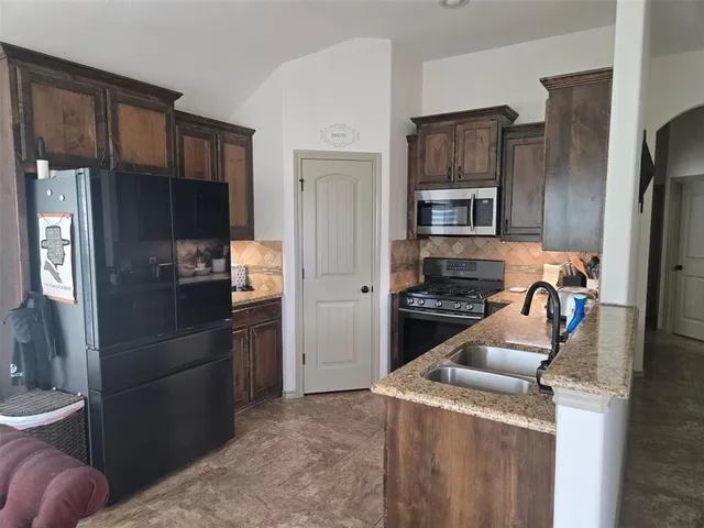 a bedroom with a bed and a flat tv screen on dresser