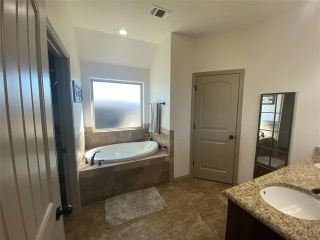 a bathroom with double sink and a mirror